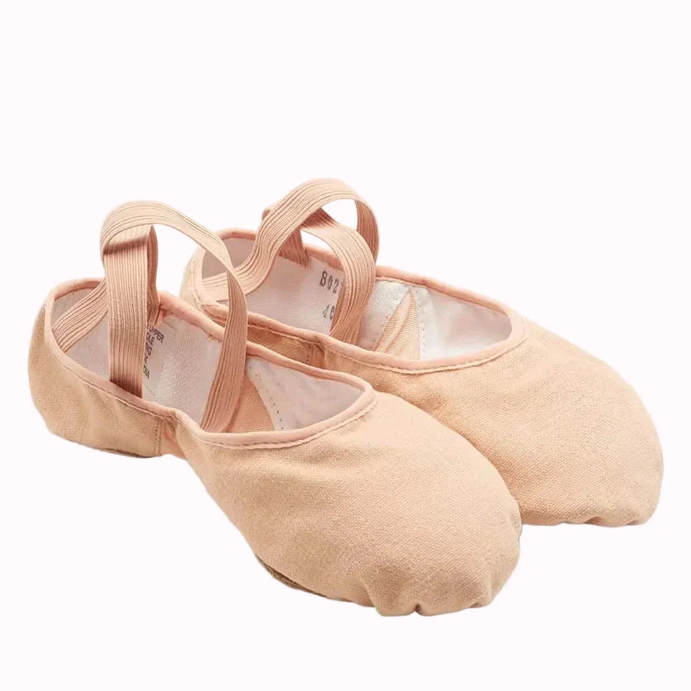 A pair of light peach-pink canvas dance shoes with elastic straps, displayed on a clean white studio background.