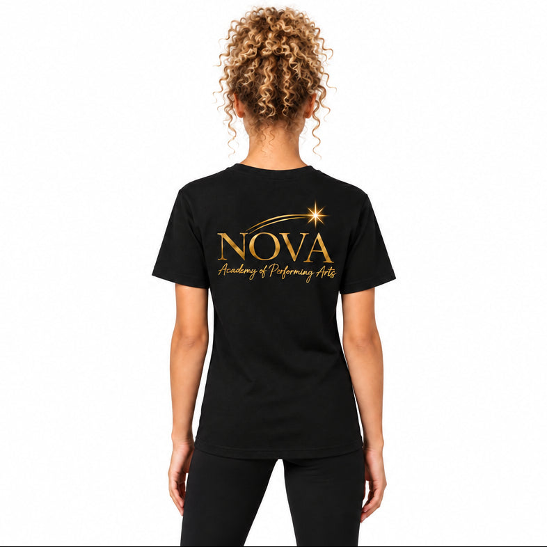 A woman viewed from the back wearing a black short-sleeve T-shirt with a gold 'NOVA Academy of Performing Arts' graphic printed on the back, paired with black leggings, against a neutral light gray background.