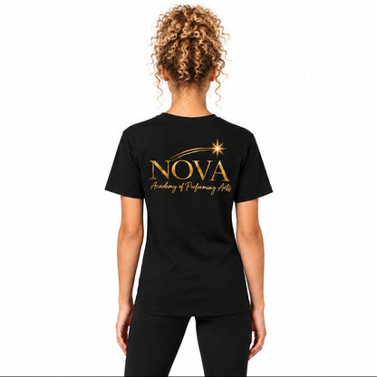 A woman viewed from the back wearing a black short-sleeve T-shirt with a gold 'NOVA Academy of Performing Arts' graphic printed on the back, paired with black leggings, against a neutral light gray background.