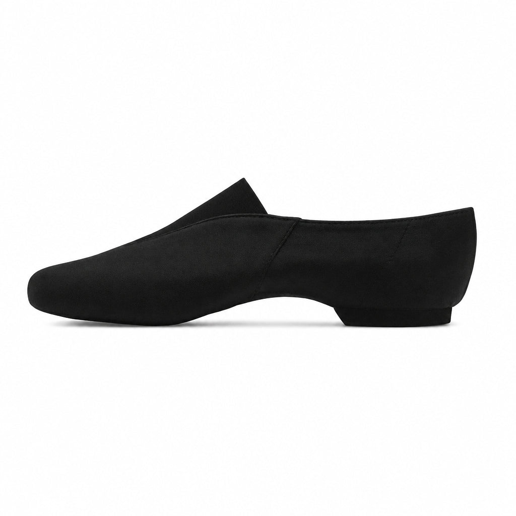 A single black slip-on loafer-style shoe shown in side profile against a warm beige textured background.