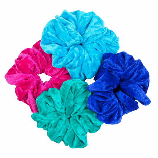 Four plush velvet hair scrunchies in bright colors: turquoise blue, magenta pink, teal green, and purple, arranged together on a plain white background.